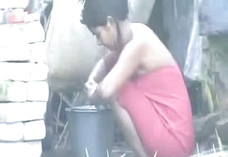 Indian neighbor lady washes outdoors as I film her on Spy webcam